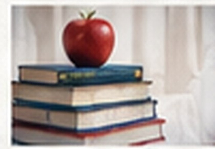 School textbooks stacked with an apple on top